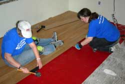 Anne and Cheryl laying a new floor in Houma, La.